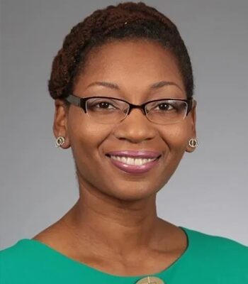 A woman with glasses and a green shirt