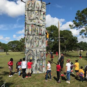 A group of people standing around an obstacle course.