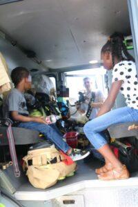 A group of people sitting in the back of a van.