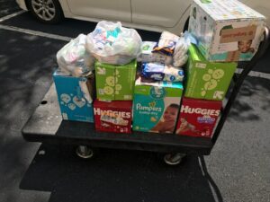 A cart full of diapers and baby wipes.