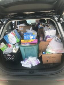 A car trunk filled with lots of items and boxes.